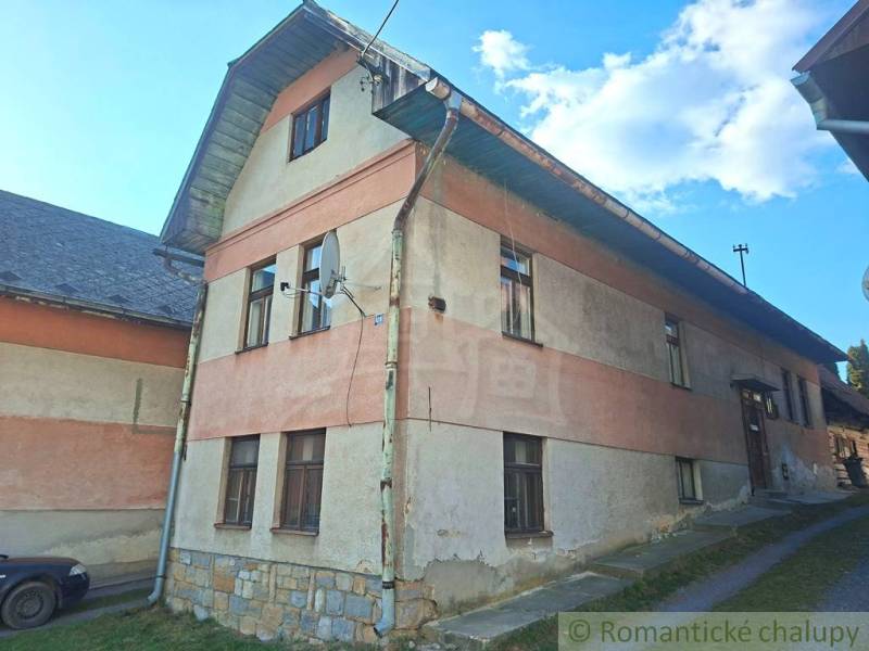 A family house in Východná with a plastered facade and a satellite dish on the wall.