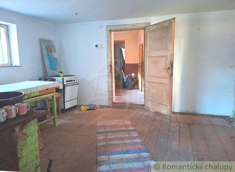 Interior of a family house with a kitchenette and a wooden decor floor.