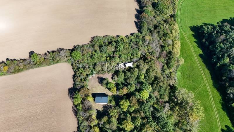 Aerial view of agricultural and forest lands in Lackov surrounded by dense forest.