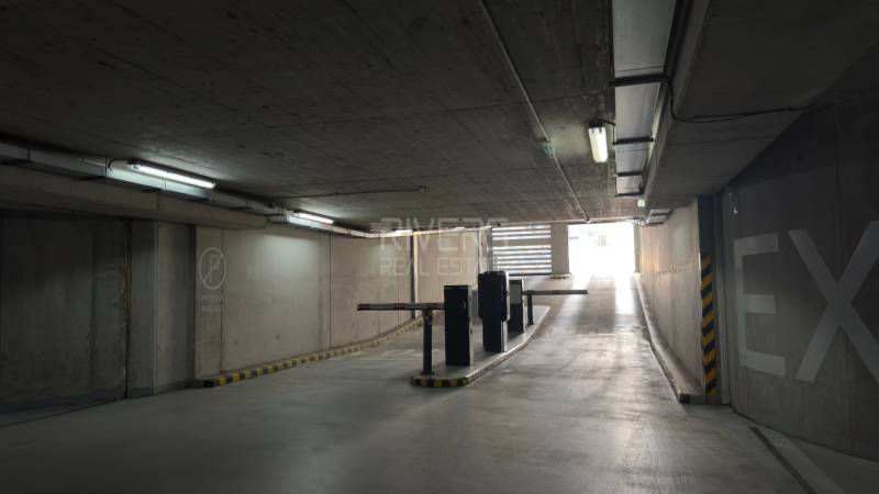 Underground garage with a ramp and the sign Private Parking.