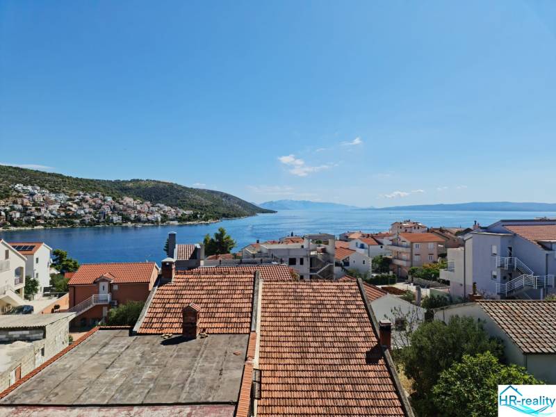 View from a holiday apartment in Ciovo over rooftops and the azure sea.