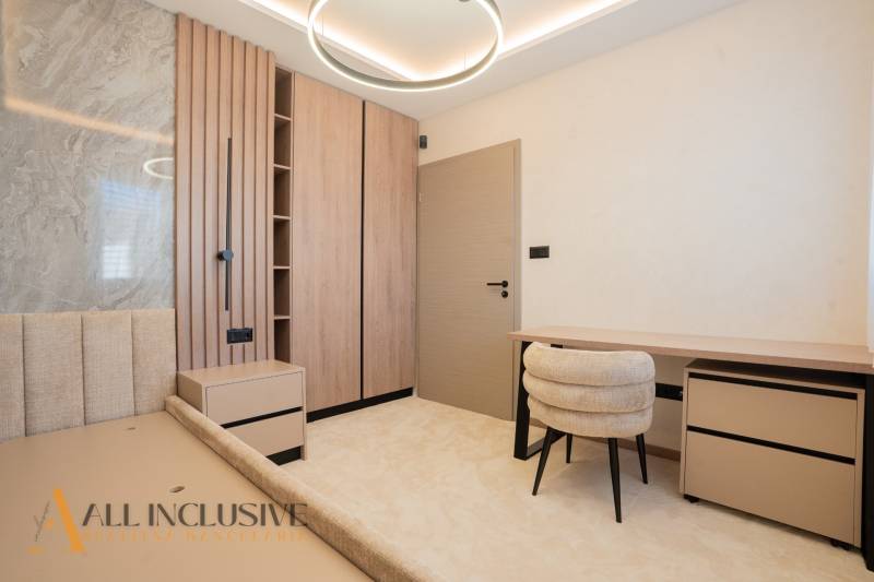 Bright room in a family house with a desk, light carpet, and wooden decor.