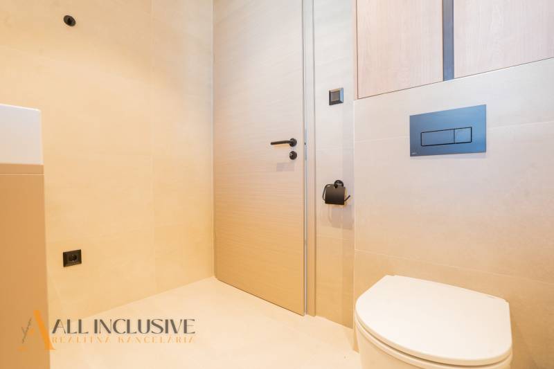 A bathroom in a family house with minimalist fixtures and light-colored walls.