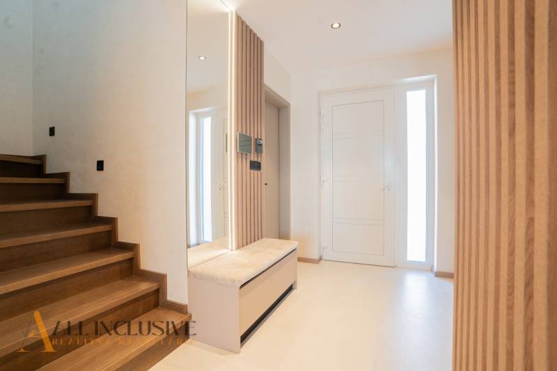 Interior of a family house with a staircase and a wooden decor floor.