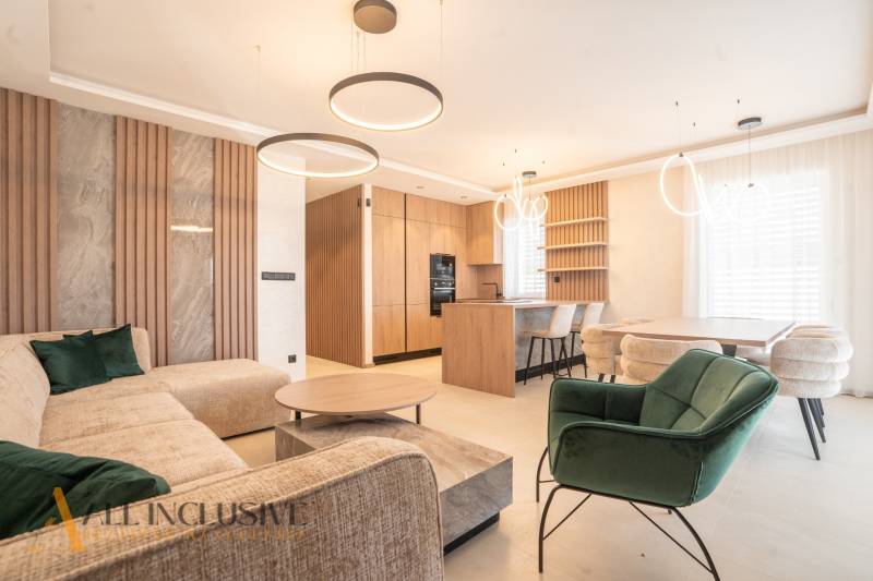 A living room in a family house with a wooden decor floor and modern furniture.