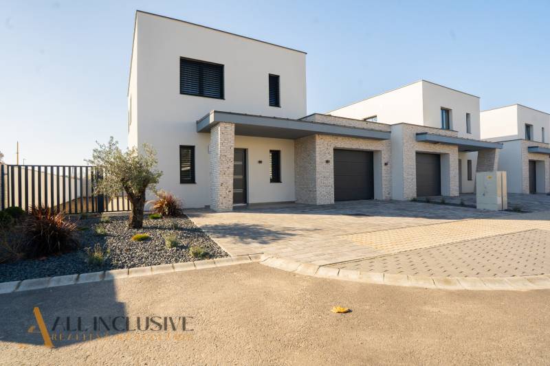 Family house in Gyor-Moson-Sopron, with a garage, minimalist front garden with stones.
