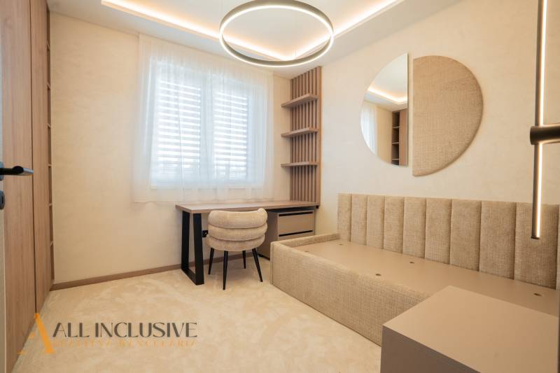 Interior of a family house with a desk, chair, and modern lighting.