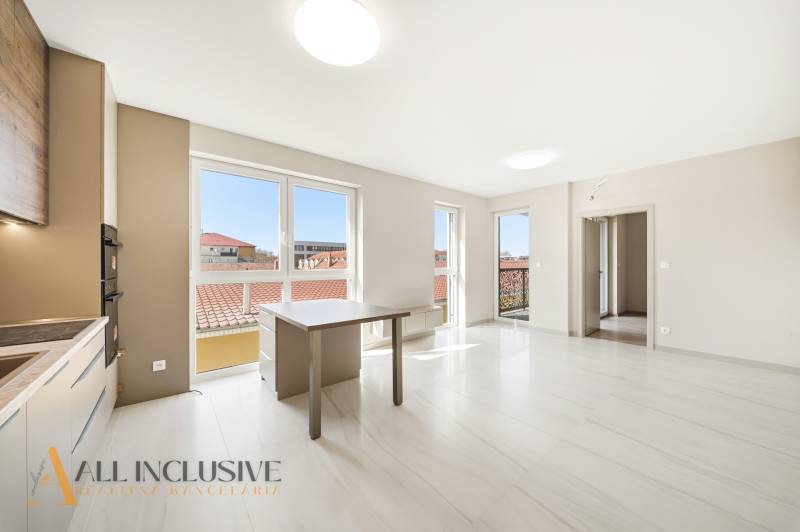 Interior of a 2-room apartment with large windows and light-colored walls.