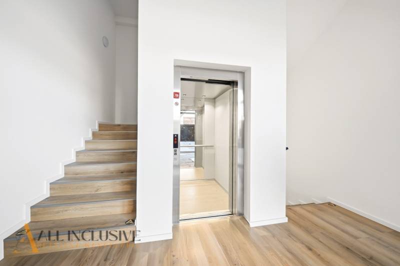 Elevator with stairs, floor with wooden decor, 2-room apartment.