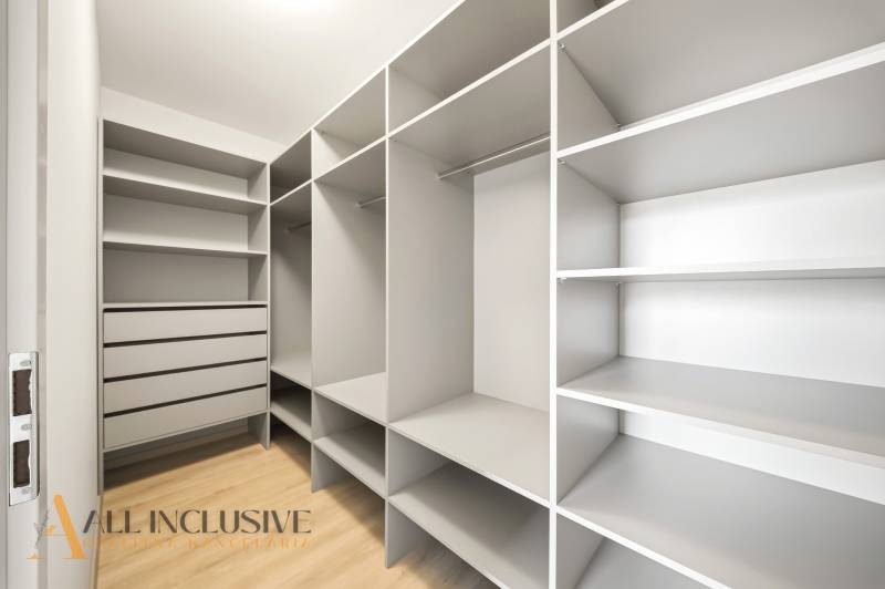 Wardrobe with shelves and drawers, floor with wood decor, 2-room apartment.