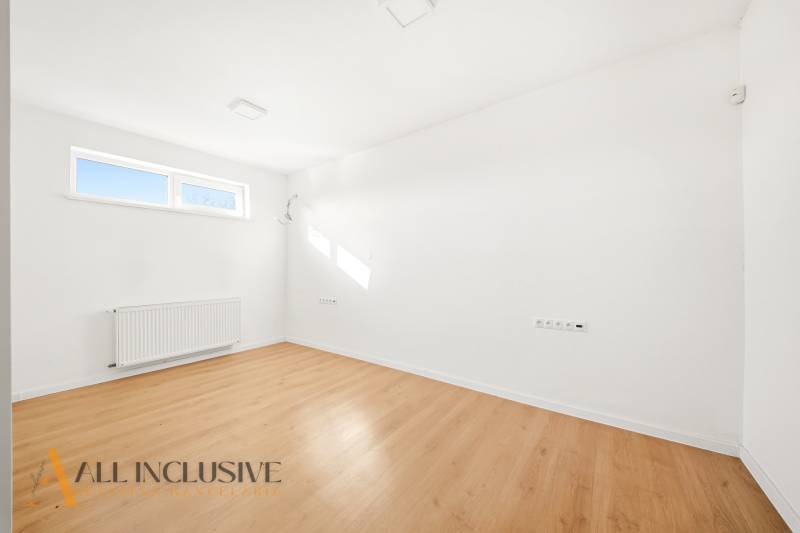Bright space with white walls and a floor with a wooden decor.