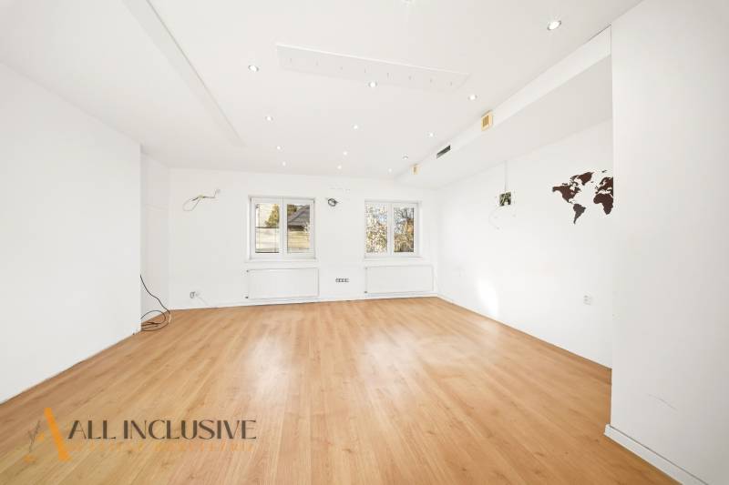 Commercial premises with a wooden decor floor and white walls.