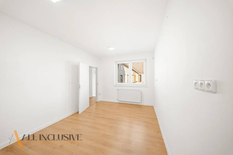 White walls and a wooden decor floor in commercial spaces.