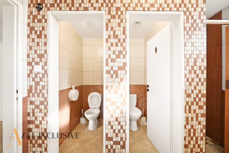 Restrooms in commercial spaces with beige and brown tiles.