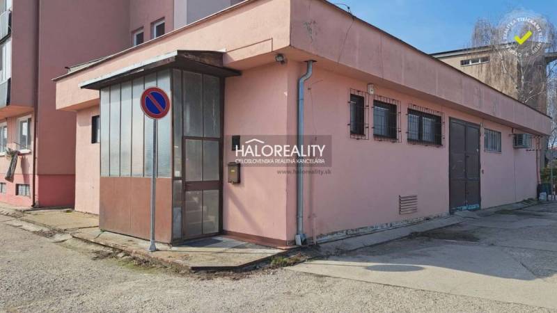 Office Building in Senec with a pink facade and metal doors.