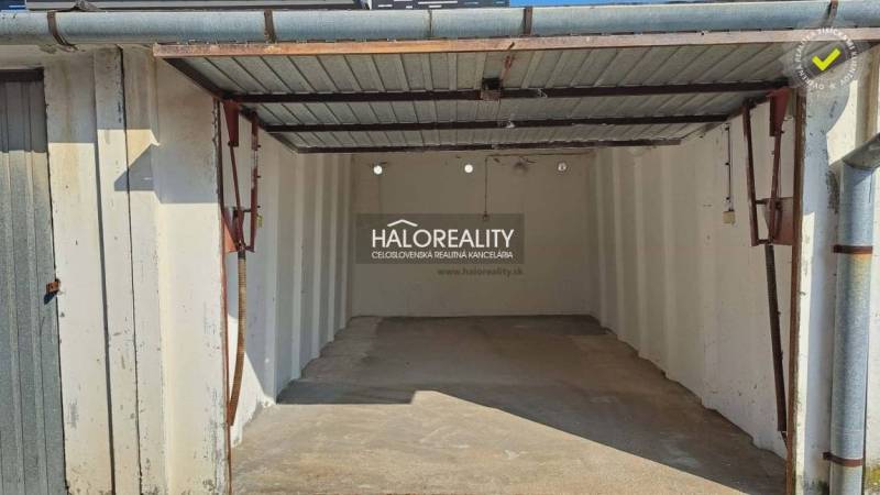 An uncovered garage in Senec with a low ceiling and a metal roof.