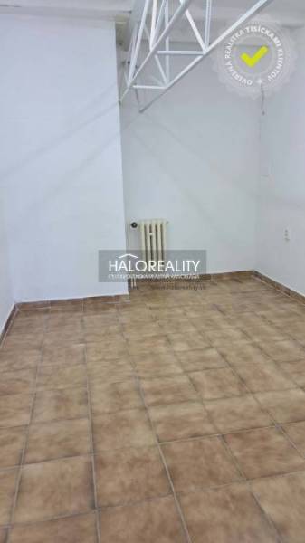 Office interior with tiled floor and white wall.