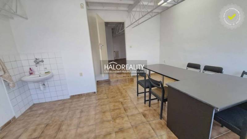 A desk and a sink with a wooden decor floor in the office.