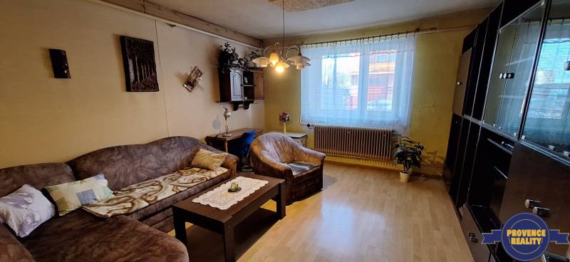 Living room in a family house with a wooden-decor floor and a sofa.