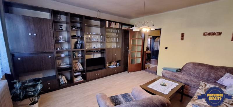 Living room in a family house with a wooden decor floor and an extensive wardrobe.