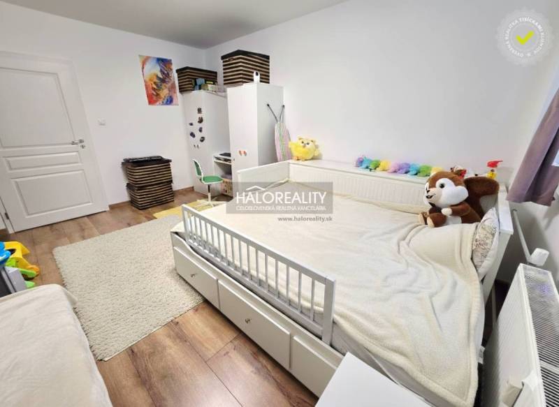 Children's room with a bed and white furniture, floor with wooden decor, 3-room apartment.