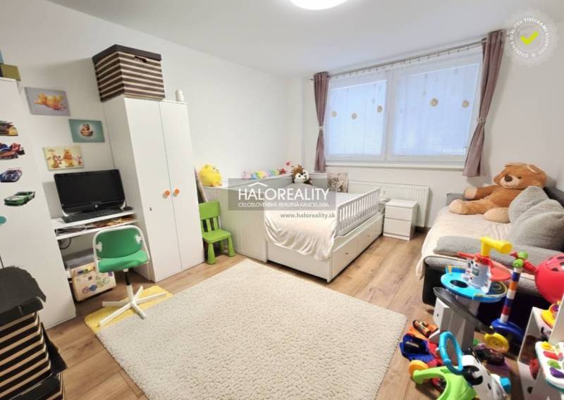 Children's room with white furniture, carpet and floor with wood decor in a 3-room apartment.