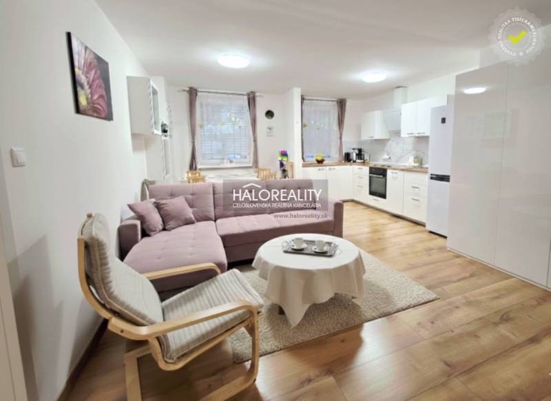 Living room in a 3-room apartment with a corner sofa, television, and wooden decor flooring.