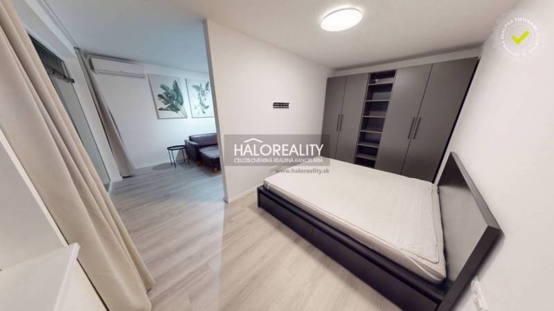 Entrance hall in a 2-room apartment with a wooden decor floor and a wardrobe.