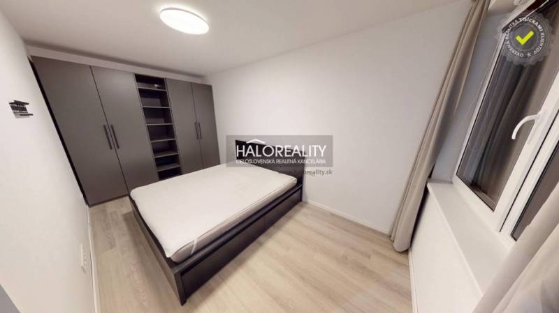 Hallway in a 2-room apartment with a wooden decor floor and a bathroom with a bathtub.