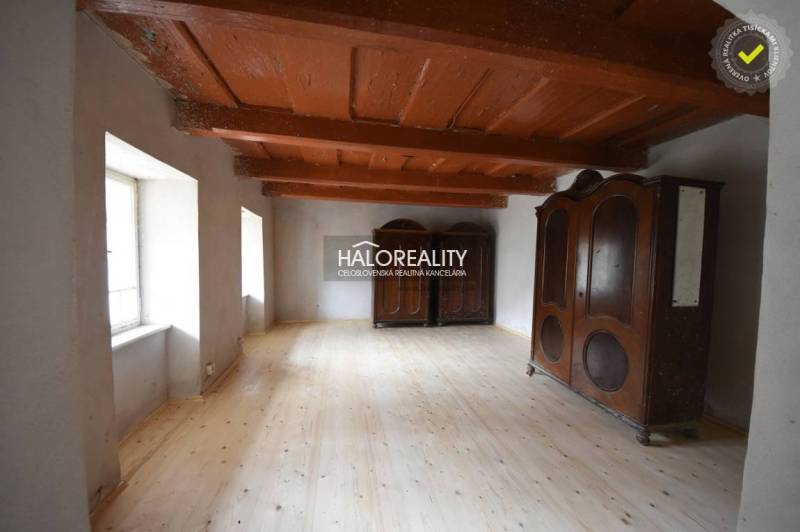 Wooden ceiling, floor with wooden decor, and massive cabinets in the cabin.