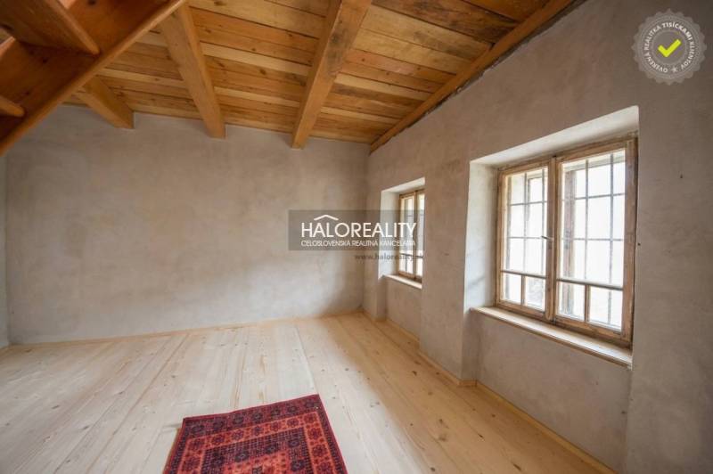 The interior of the cabin with a wood-decorated floor and wooden ceiling.