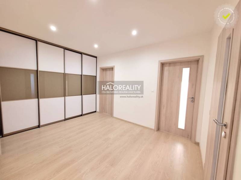 Interior of a 3-room apartment with a wooden decor floor and built-in wardrobes.