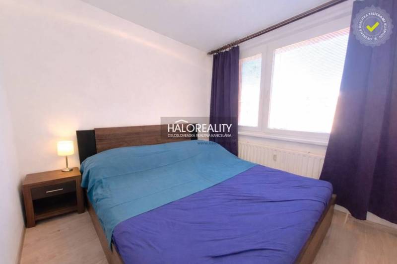 Bedroom in a 3-room apartment with a double bed, curtains, and a nightstand.