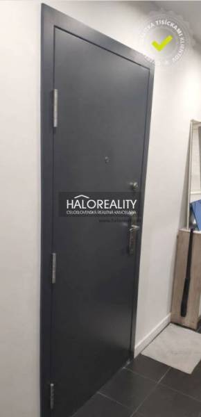 Entrance door in a 3-room apartment with a dark design and white walls.