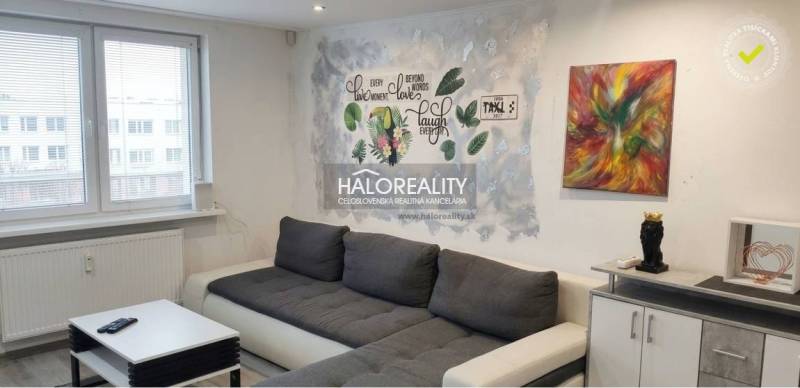 Living room in a 3-room apartment with a comfortable sofa and a decorative wall.