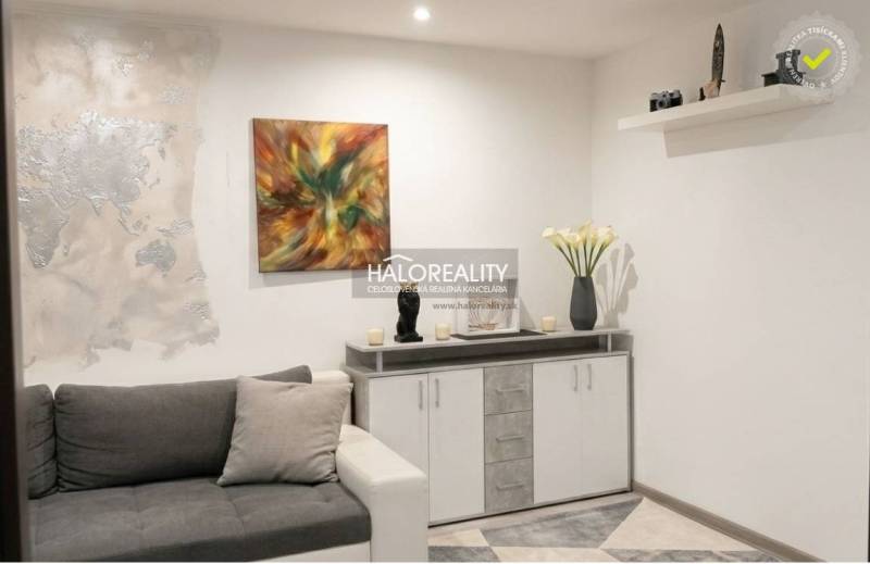 Living room in a 3-room apartment with modern wall decoration and a comfortable sofa.
