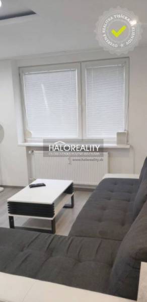 Living room in a 3-room apartment with a dark gray sofa and a coffee table.