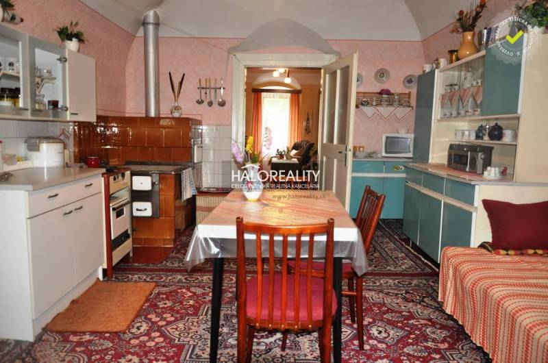 A kitchen full of vintage furniture and decorations offers a cozy space in a family home.