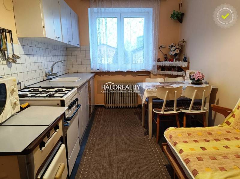 Kitchen in a 2-room apartment with a kitchen table and a gas stove.