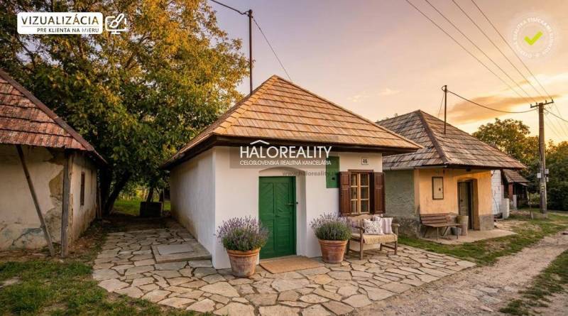 Traditional houses in the gardens of Mýtne Ludany surrounded by greenery at sunset.
