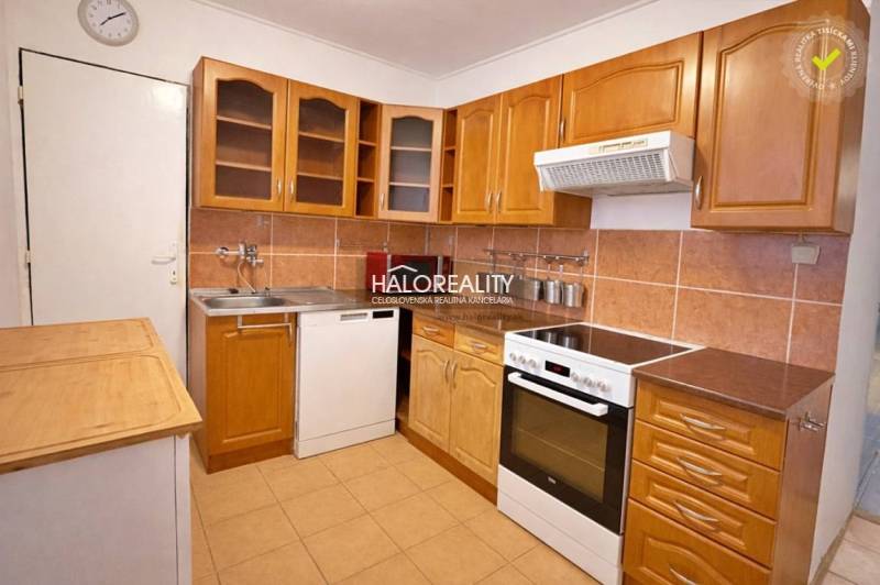 A kitchen in a 4-room apartment with a wooden floor decor and a kitchenette.