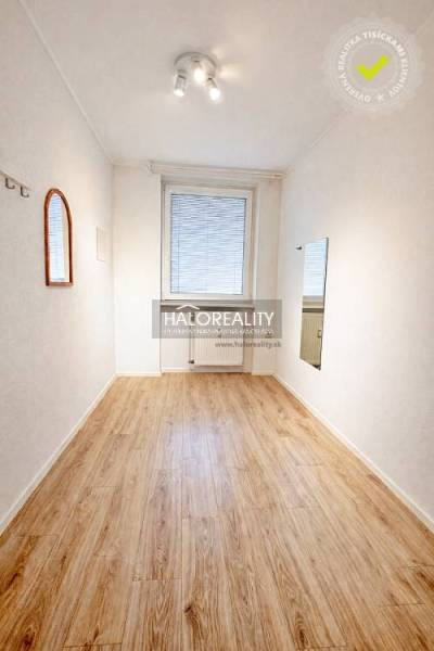 A bright room with a wooden decor floor in a 4-room apartment.