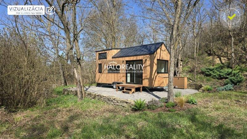 A small wooden house on a plot surrounded by trees in the recreational area of Zalaby.