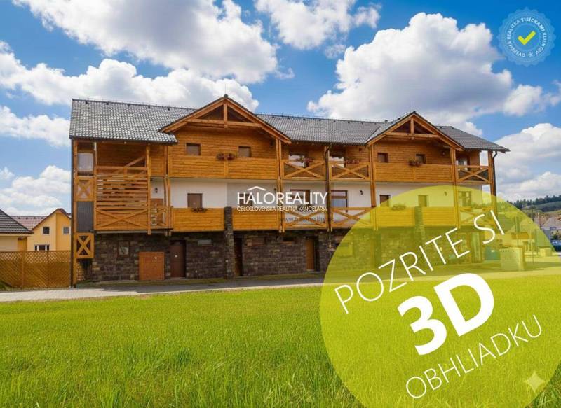 A wooden building in Demänovská Dolina with a blue sky and green grass.
