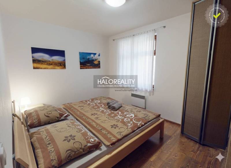 Bedroom with a double bed, light walls, and a floor with a wood decor in a 3-room apartment.