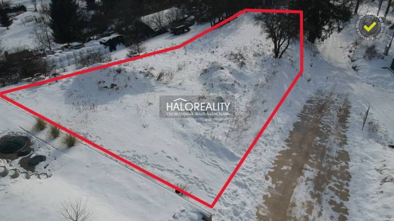 Snow-covered residential lands in Liptovské Beharovce, bordered by a red line.