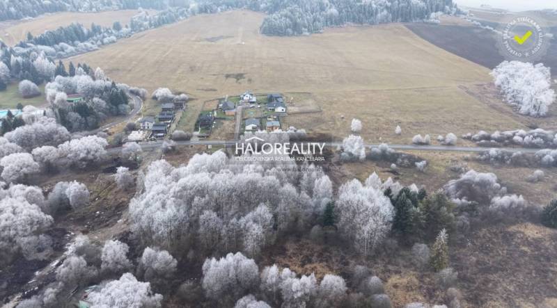 Snow-covered recreational lands in Liptovský Ján with forest stands and agricultural landscape.
