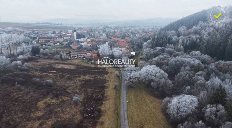 Winter landscape in Liptovský Ján with a view of recreational grounds and a snowy forest.