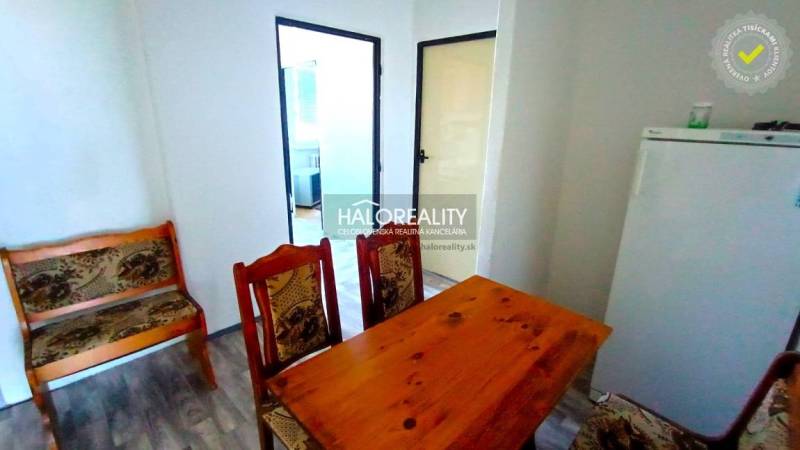 Dining table and chairs, classic design, wooden decor flooring in a 2-room apartment.