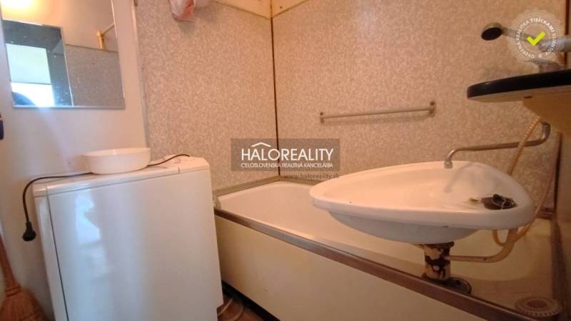 Bathroom in a 2-room apartment with a bathtub, sink, and washing machine.